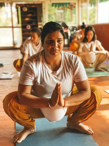 A student holds Malasana (Garland Pose) with focus and stillness. This grounding posture is excellent for the hips and lower back. We teach you to find comfort even in discomfort, a key lesson both on and off the mat.