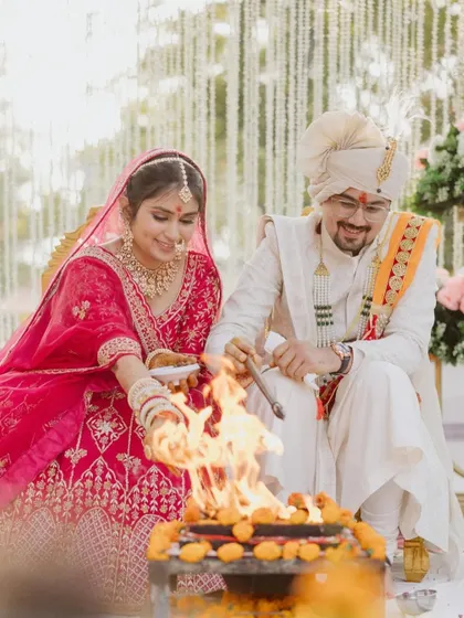 A sacred moment from the wedding ceremony, as the couple participates in the rituals around the holy fire.