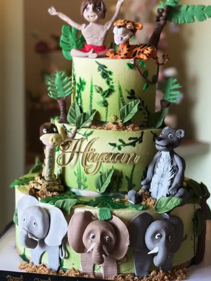 Welcome to the wild side! This jungle-themed cake is roaring with flavor, featuring adorable, handcrafted fondant animals like elephants, monkeys, and lions, perfect for a little explorer's party.
