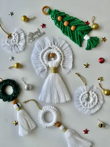 My collection of white and green macrame Christmas ornaments, including a beautiful angel, a tree, wreaths, and tassels.