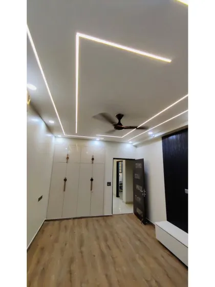 A sleek, modern wardrobe with high-gloss white doors and minimalist handles. The design is clean and contemporary, providing a large amount of storage without overwhelming the space.