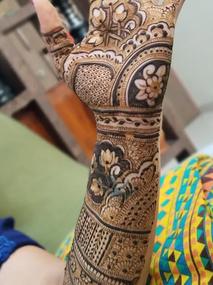 A close-up of a design with beautiful lotus and other floral motifs. The shading technique makes the flowers look like they are blooming on the skin.