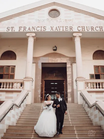 A classic shot of a Christian couple descending the church steps after their wedding, ready to start their new life together.