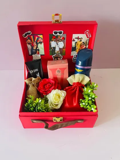 A Rakhi hamper designed for a brother and sister-in-law. I personalized the inside lid with their photos and filled the red suitcase box with grooming products and treats.