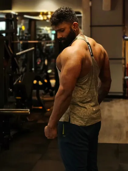 A strong back and shoulder combination is crucial for a balanced physique. This pose shows the definition in the rear delts, traps, and lats.