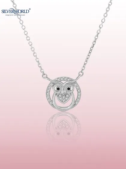 A whimsical owl pendant, symbolizing wisdom, is crafted with a zirconia-studded body and a heart detail. This charming necklace is a favorite among our younger customers.