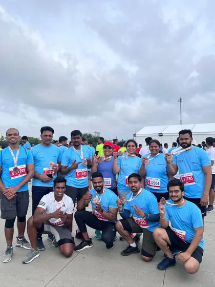 The whole crew celebrating with their medals after the Bengaluru 10k. Training for and completing a race as a team is an incredible experience.