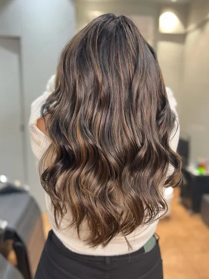 A golden bronze balayage that adds warmth and a metallic shine to the hair. It's a luxurious and eye-catching color choice.