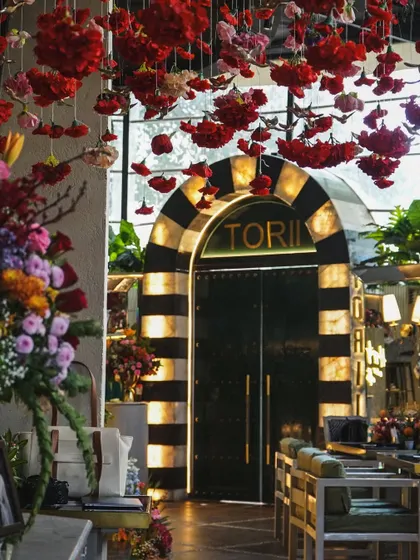 The grand entrance to Tori Mumbai, decorated for a Mehendi party. The hanging red flowers and the restaurant's signature archway created a stunning first impression.