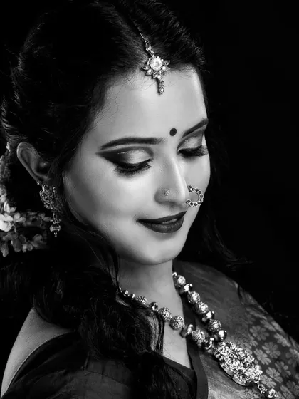 A timeless black and white portrait. This shows how well-structured makeup, especially the defined eyes and contoured features, translates beautifully into monochrome photography.