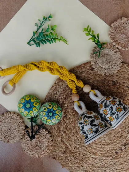 Our 'Green Quoted Combo' is perfect for plant lovers. This set includes two yellow macrame bells, four green glass frames with quotes, a wooden plank, and two ceramic hooks to complete the look.