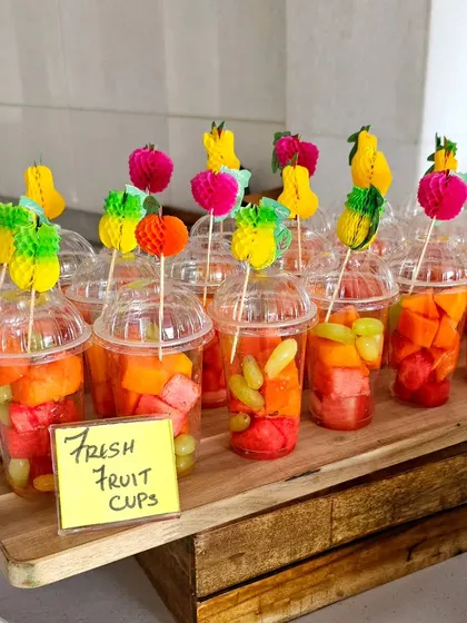 Cute little fresh fruit cups with colorful decorative picks, a healthy and fun snack for guests of all ages.