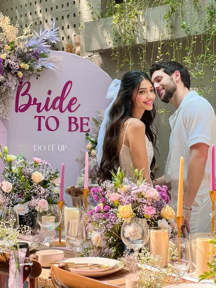 A 'Bride to Be' celebration, designed as a chic and floral-forward bridal shower. The tablescape is filled with flowers, and the custom backdrop creates the perfect photo opportunity for the bride.