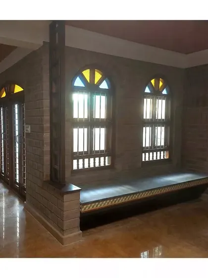 A duplicate of the room with the built-in window seat and arched windows.