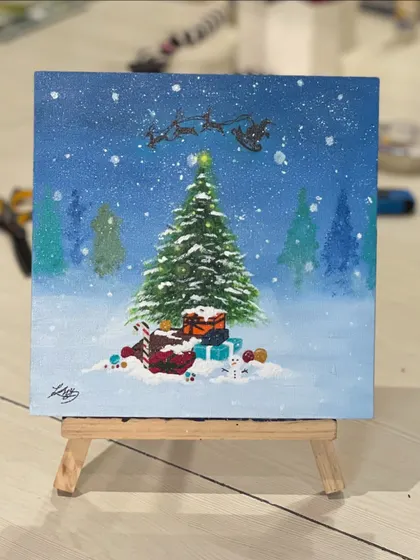 A beautiful Christmas-themed painting on a mini canvas. This winter scene, complete with Santa's sleigh, was created during our holiday celebration.