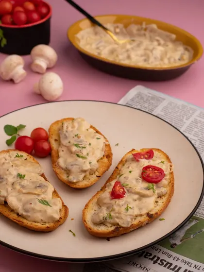 Creamy mushrooms on toast, styled for a cozy cafe vibe. The soft lighting and simple plating make this snack look elegant and comforting, perfect for a brunch menu.