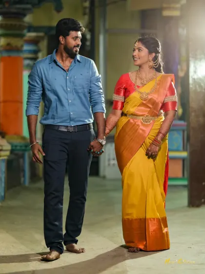 A happy portrait of the couple walking hand-in-hand during their engagement celebration.