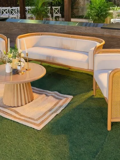 A chic and modern lounge area with cane furniture and neutral tones. This cozy corner provided a comfortable and stylish space for guests to relax and mingle.