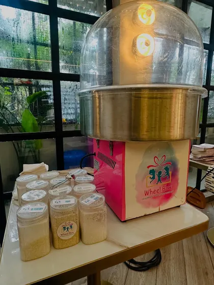 A close-up of our cotton candy machine and the variety of organic sugar flavors we bring to each event, ready to be spun into delicious treats.