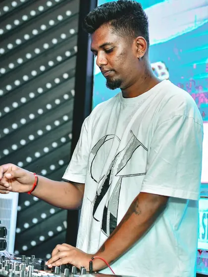 A shot of me at the decks, focused on the mix. I'm always working to ensure the transitions are smooth and the energy keeps building.