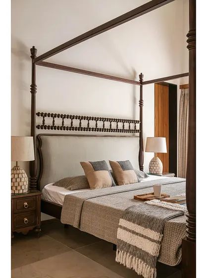 Another detail of the master bedroom, focusing on the texture of the bedding and the elegant, traditional form of the four-poster bed.