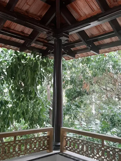 A repeated view of the finished balcony, emphasizing the harmony between the restored wooden elements and the natural surroundings.