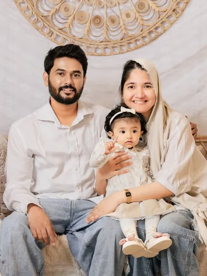 A warm and loving family portrait in our boho-chic setup. The natural textures and neutral colors create a cozy and inviting atmosphere.