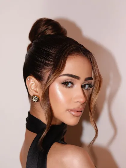 A beautiful profile shot that captures the glow and softness of the makeup.