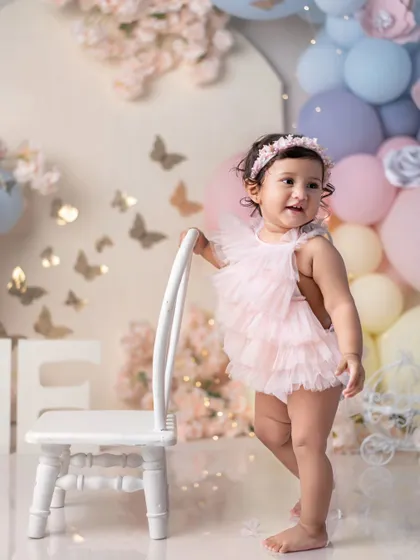 A princess in her pink tutu, ready for her first birthday party. The setup is so dreamy and sweet.