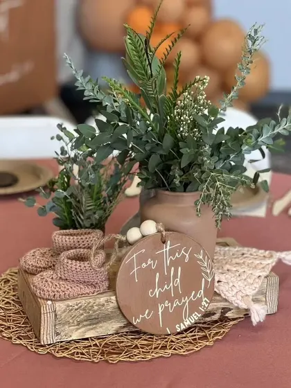 "For this child we prayed." A heartfelt and personal detail for a baby shower tablescape, combining rustic elements with a custom-engraved sign.