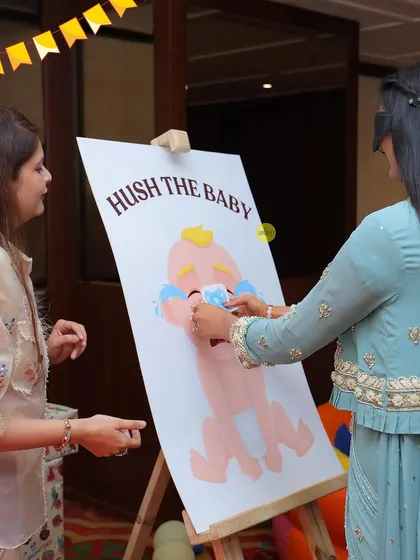 Fun and games at the carnival! This "Hush the Baby" game was a hit with guests of all ages at Darsh's first birthday party.