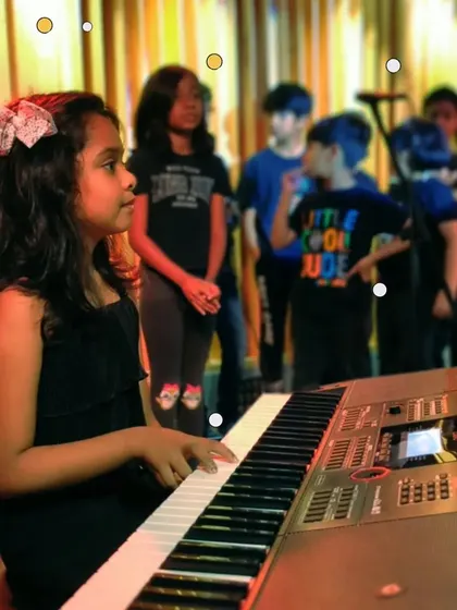 A young pianist performs at the final recital of our summer camp. The camp culminates in a showcase where the kids can show off everything they've learned.