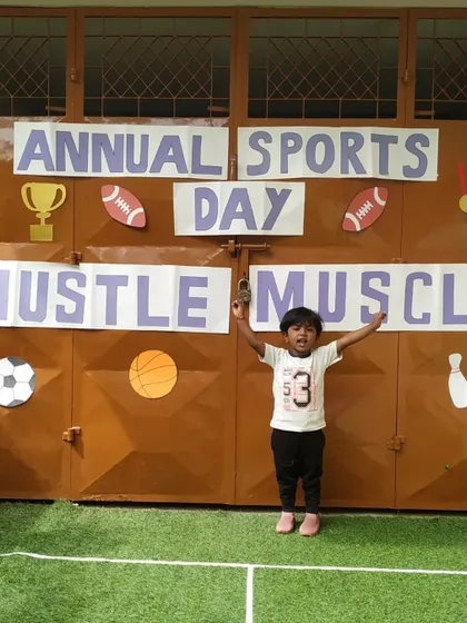 A triumphant pose from one of our youngest athletes. Our Sports Day is designed to be fun and accessible for all age groups.
