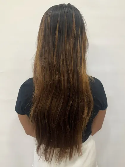 Before the "Hazelnut Chocolate Truffle." The hair is long and has some previous color, ready for a deep, rich, and glossy refresh.