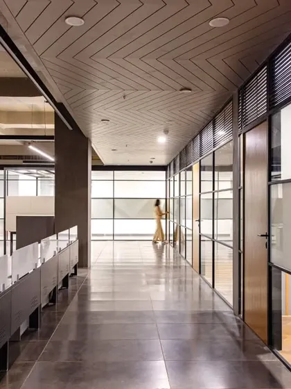 The main corridor at Anthea Pharma, showcasing the balance of warm and industrial elements. The design was rooted in simplicity, allowing functional workspaces to harmonize with softer elements inspired by Hyderabad's local traditions.