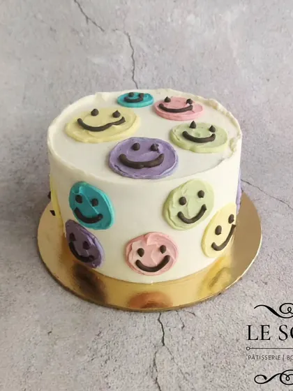 Simple buttercream art can be so effective. This half-kg Chocolate Butterscotch cake is decorated with colorful, happy smiley faces for a cheerful birthday treat.