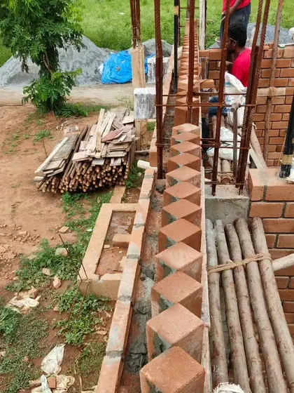 The process of laying bricks for a wall.