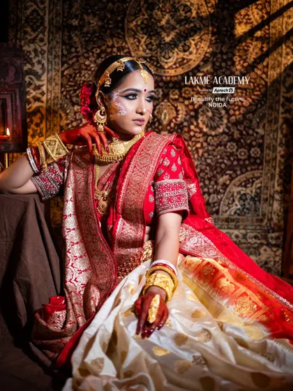 Master the art of regional bridal makeup with our specialized training. This stunning Bengali bridal look, inspired by the elegance of "Paro," showcases the intricate details, from the traditional chandan art to the classic red and gold saree styling.