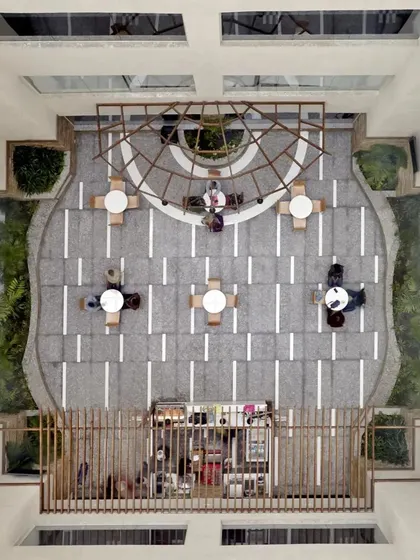 An aerial view of the atrium shows the symmetrical and organized layout. This perspective highlights how we use geometric patterns and open space to create a sense of order and tranquility from every angle.
