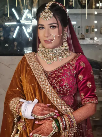 One of my prettiest brides, looking elegant in a unique velvet and pink lehenga. The makeup is soft and complements her beautiful outfit.