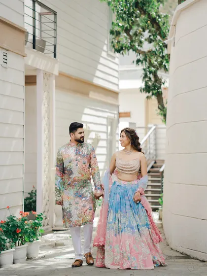 A candid moment of the couple walking and talking through a charming lane. This natural interaction is what makes pre-wedding ceremony photos feel authentic and special.