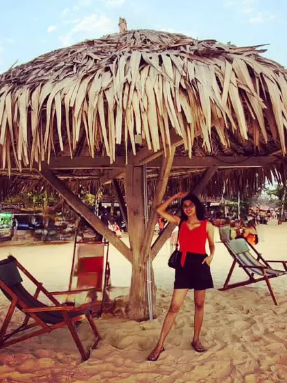 Finding shade under a rustic beach shack at Malpe Beach. This captures the laid-back, tropical vibe of the Karnataka coastline.