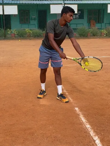 A player prepares to serve during a practice match, showcasing the focused mindset required for high-stakes points.