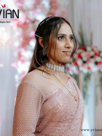 Ready for the reception party. This is a soft glam look with a sparkling saree, perfect for an evening of celebration. We also styled her hair with simple accessories to complete the look.