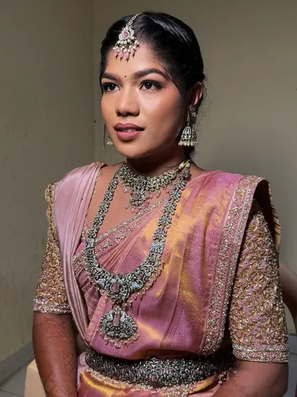 A profile shot of Lekhana's reception makeup. The matte eyeshadow is beautifully blended, and her skin has a healthy, natural glow.