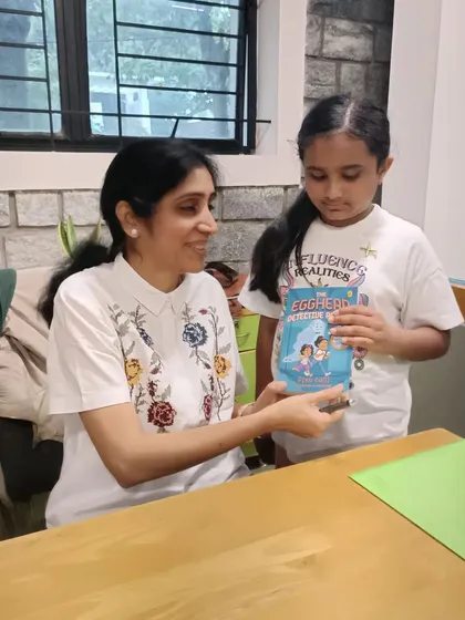 Author Pika Nani shares a smile while signing a book for a young fan. These one-on-one interactions make the stories and characters feel even more real and exciting.