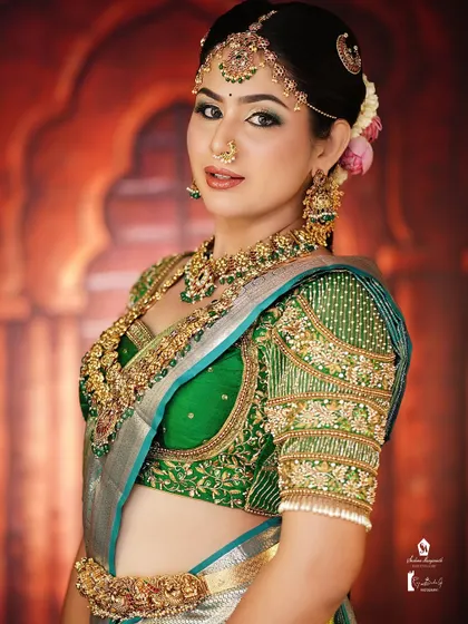 A classic South Indian bridal pose. The makeup is bold enough to stand out in photos yet looks elegant in person.