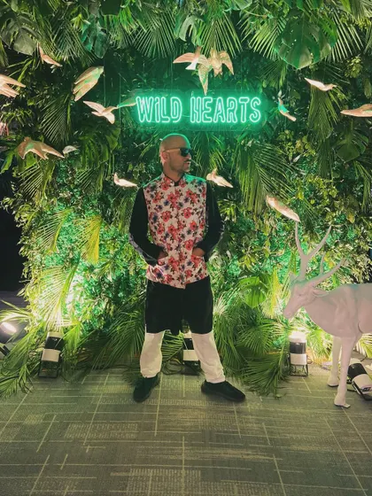 Looking over my shoulder at the 'Wild Hearts' sign. The attention to detail at this event was fantastic, creating a perfect backdrop for a memorable night.