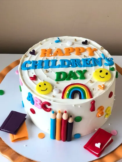 A bright and cheerful cake to celebrate Children's Day, decorated with letters, numbers, and school supplies.