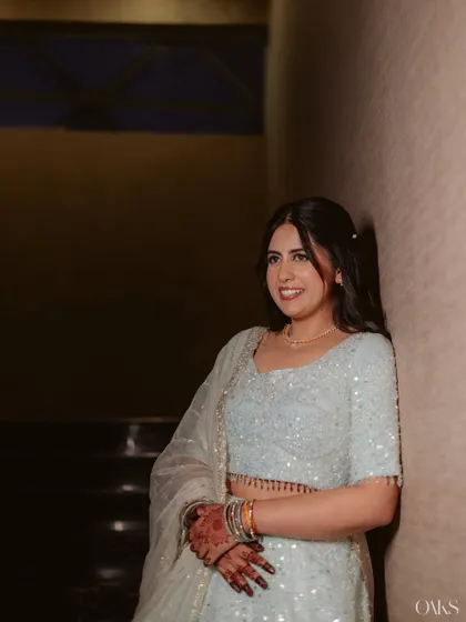 A candid, relaxed portrait. The makeup is soft and natural, allowing her personality and happiness to shine through.